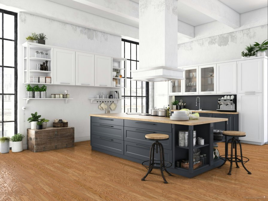 Modern kitchen with warm hardwood flooring, white cabinets, a dark gray island, wood countertops, and large black-framed windows.