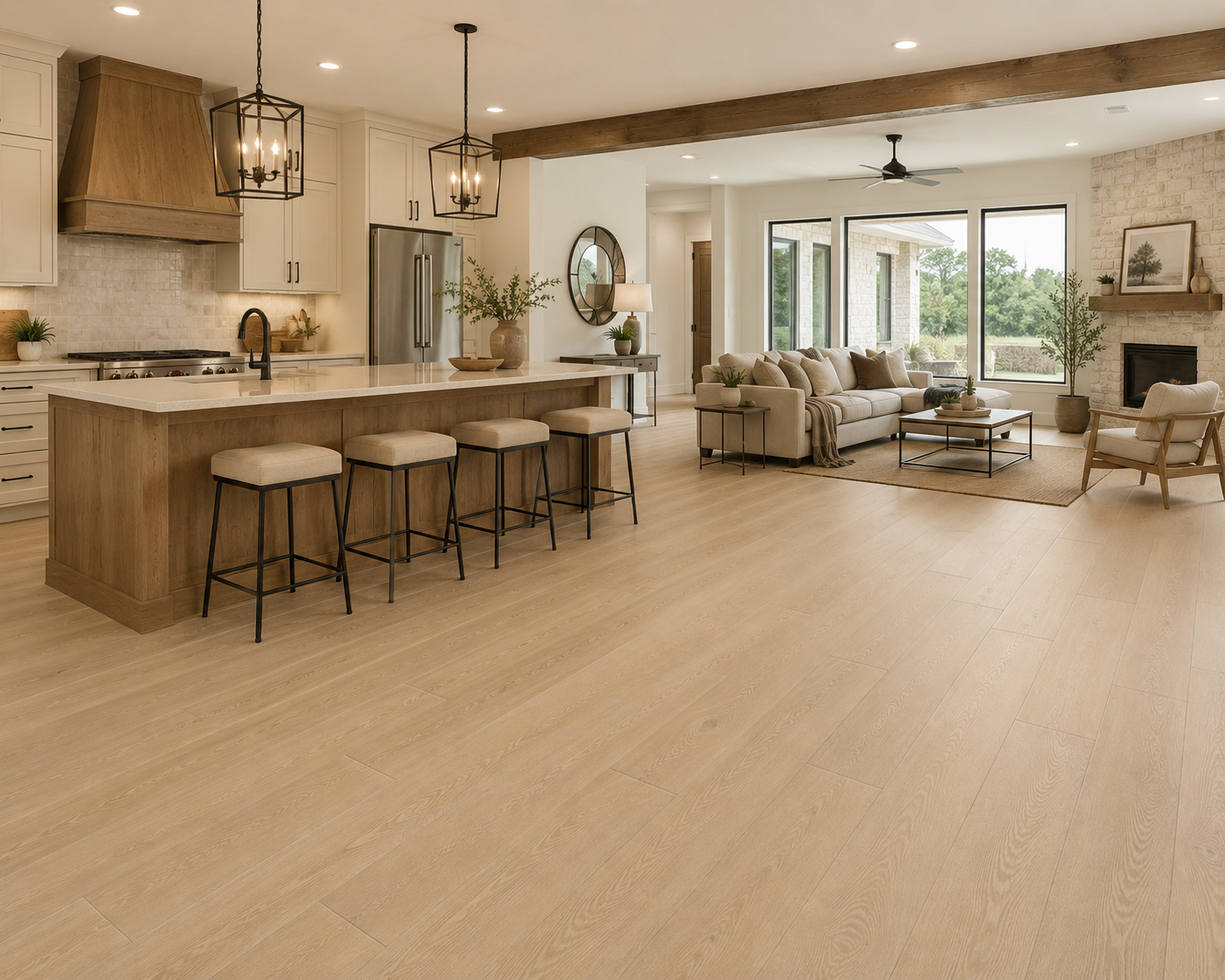 Open-concept kitchen and living room with light wood-look COREtec flooring, a large kitchen island, neutral furnishings, and expansive windows.
